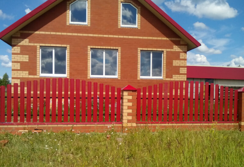 Забор из металлоштакетника цвета рубин с кирпичными столбами в Казахстане фото 2